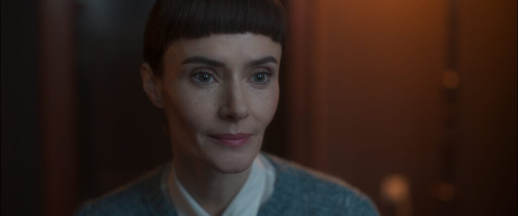 Close-up of a woman with short dark hair and blunt fringe