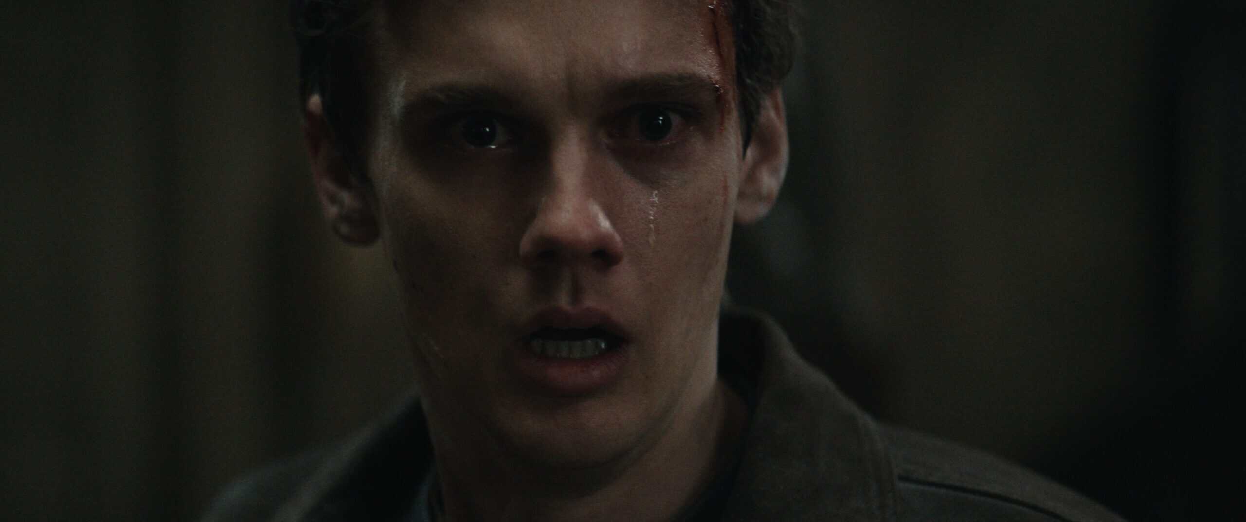 A closeup of Hunter Doohan as Joseph, looking shocked.