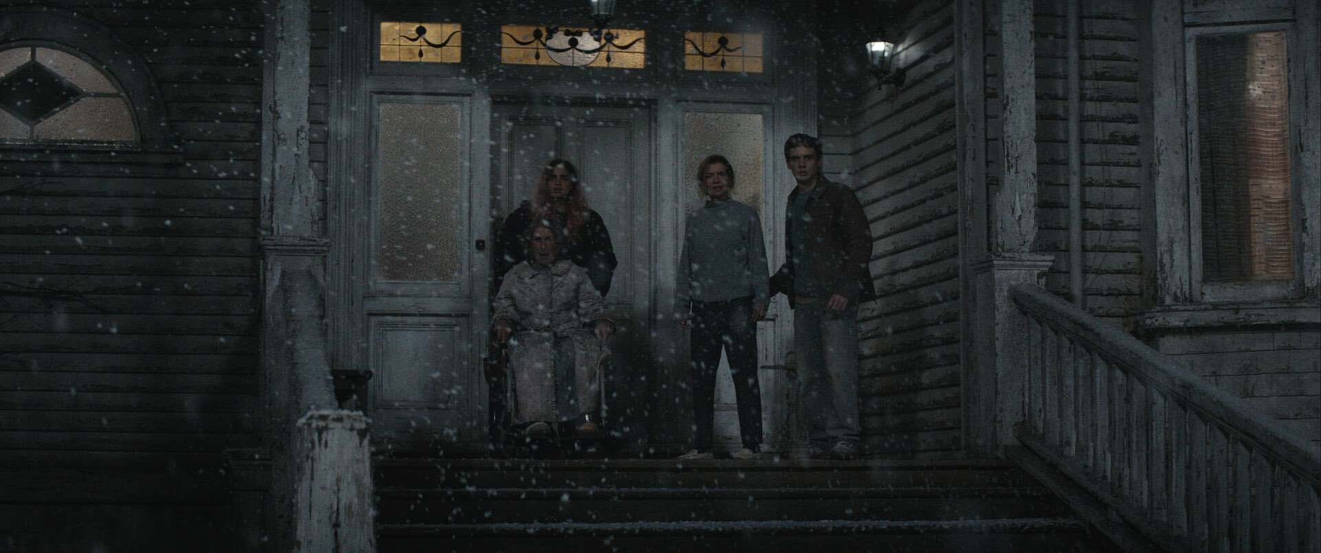 Alice, Polly, Susan and Joseph are on the stairs of the family home as it's snowing outside. They look out in the distance in disgust and shock.